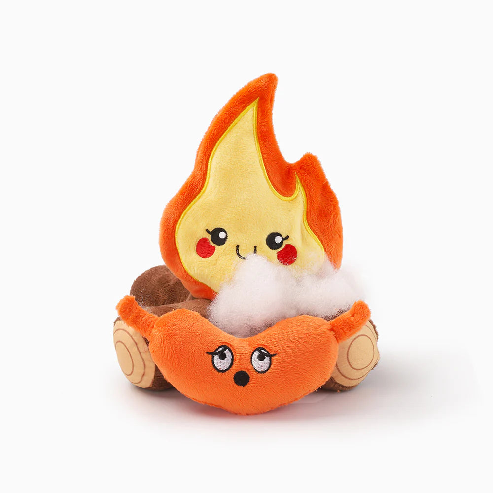 Hugsmart pet plush toy shaped like a campfire flame with a cute face on a white background with a sausage plush toy below it looking startled