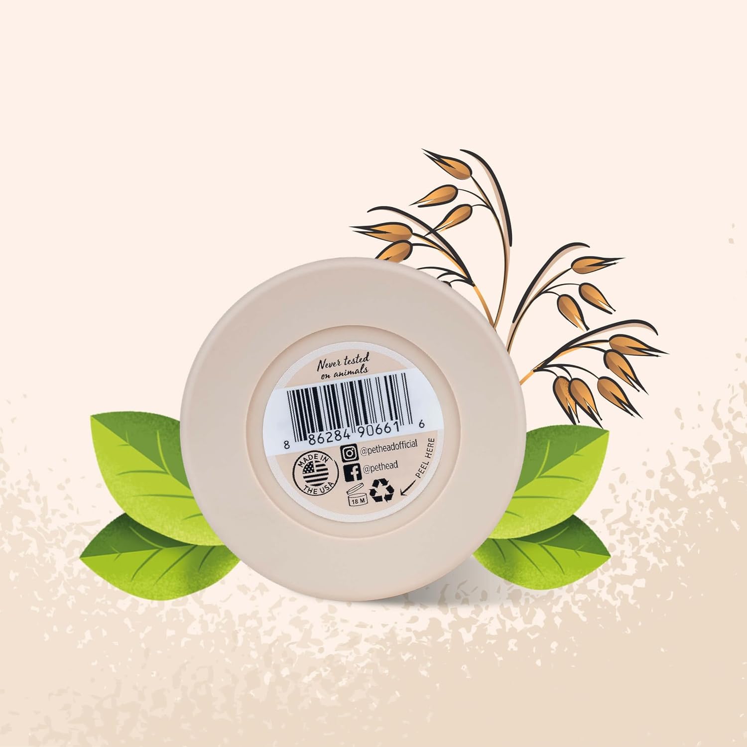 Round beige container of Pet Head oat paw butter with a label on a beige background with green leaves and brown branches.