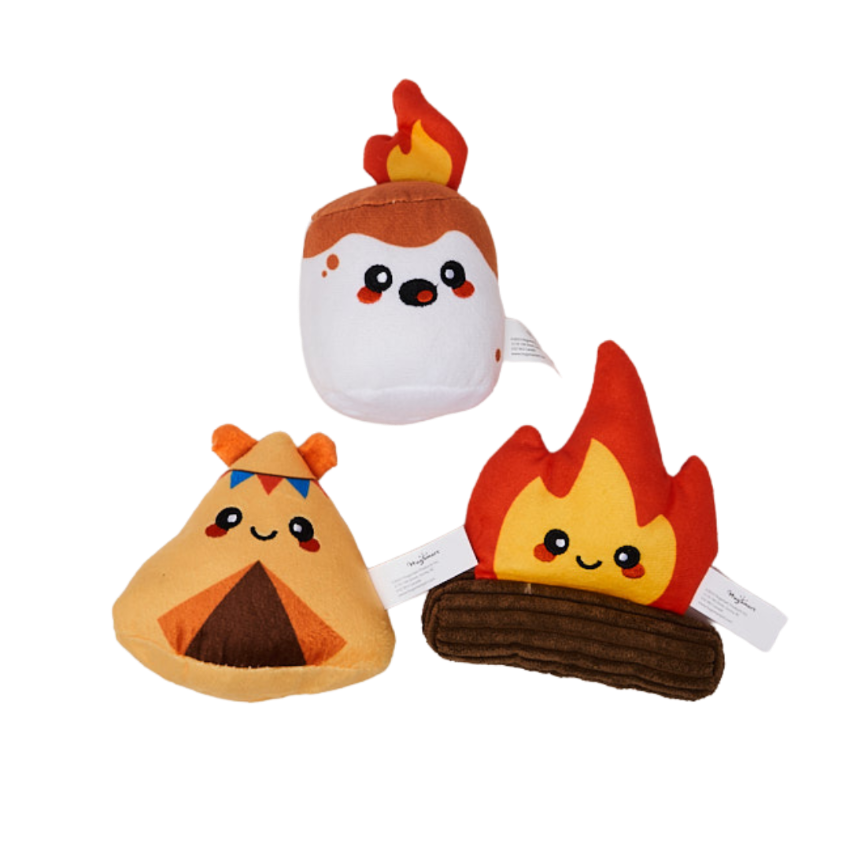 Three cute HugSmart plush toys shaped like a campfire, marshmallow, and a tent on a white background sitting in a triangle