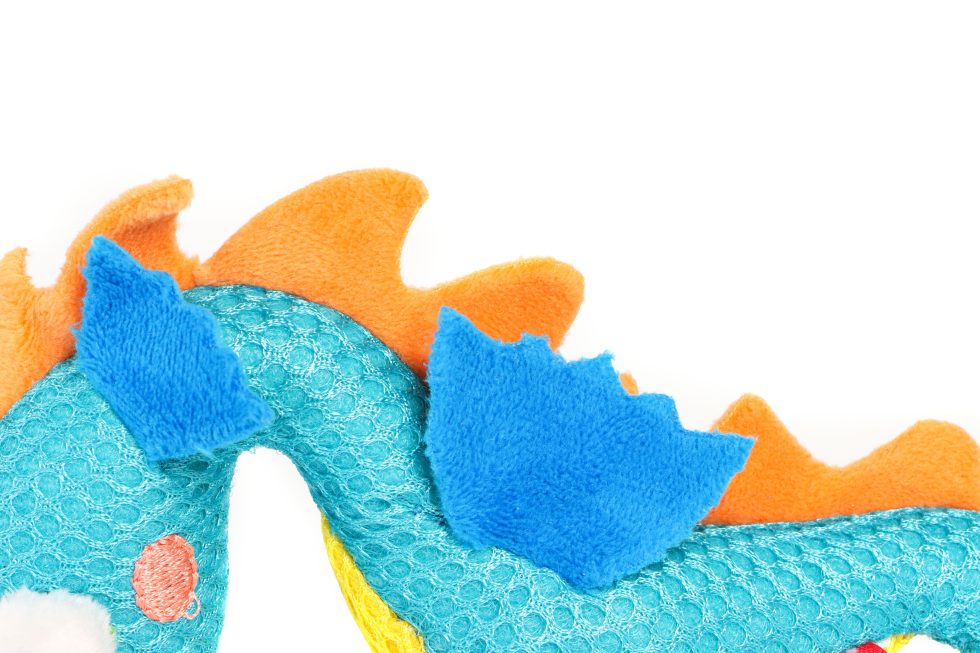 Close-up of a blue and orange seahorse toy on a white background