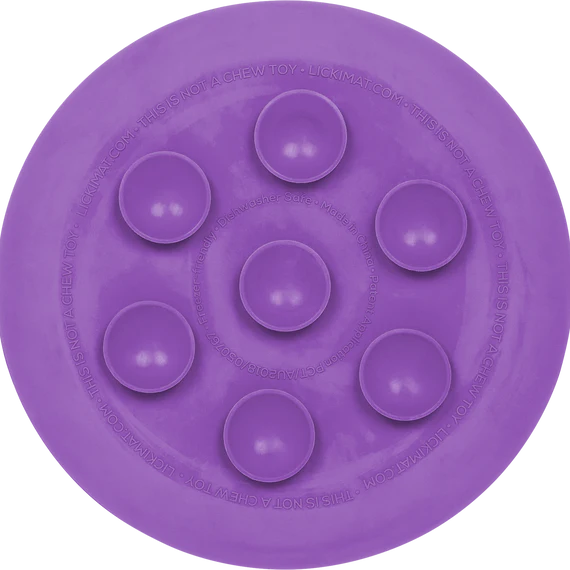 Purple ufo dog lickimat with raised circular suction caps on a white background