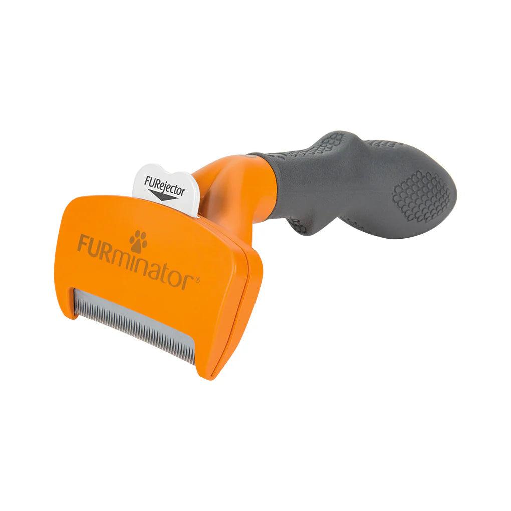 Orange and gray FURminator pet grooming tool on a white background