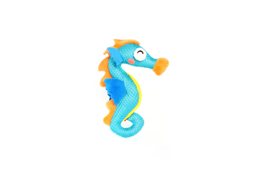 Blue and orange smiling seahorse toy on a white background
