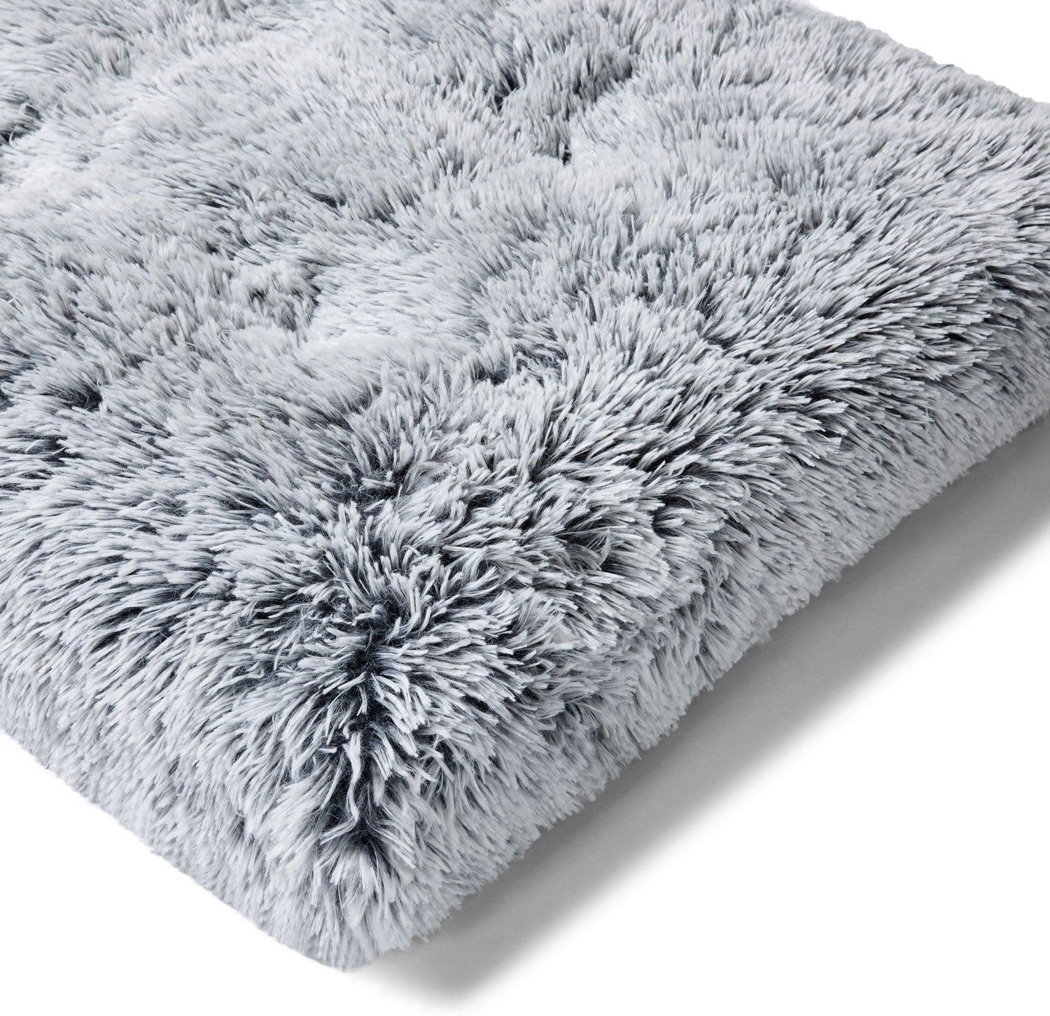 Close-up of a fluffy gray Snooza pet bed on a white background