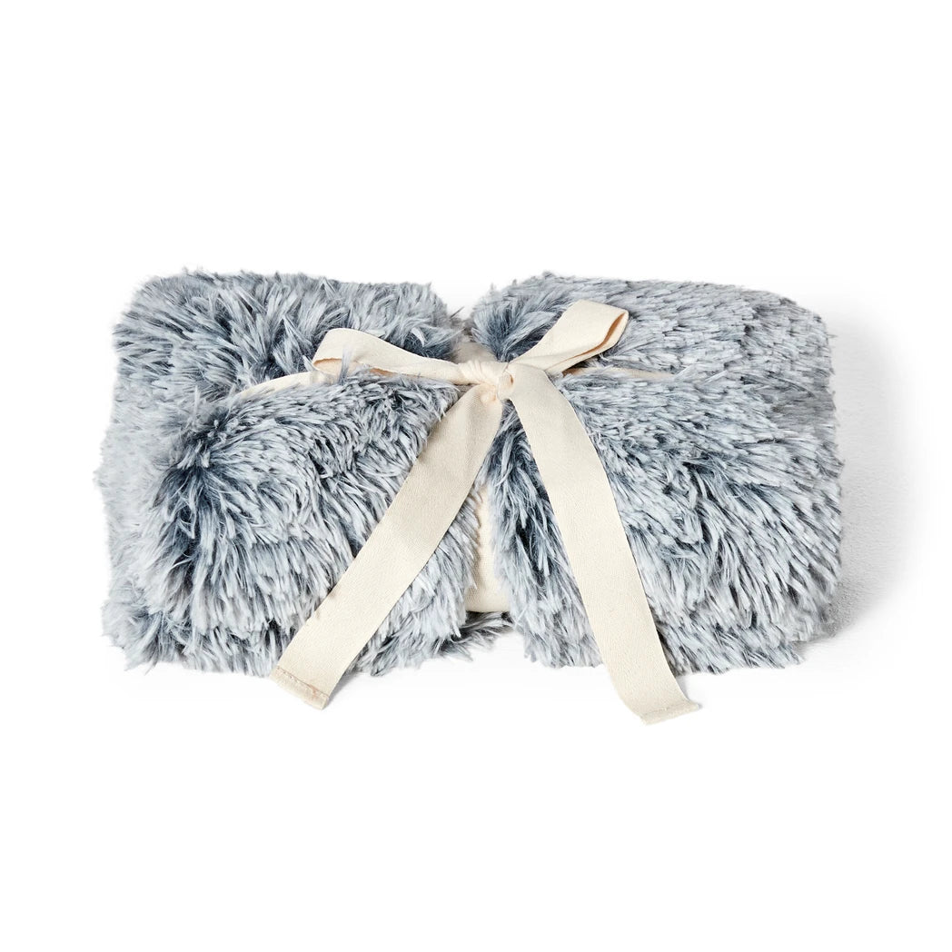 Gray fluffy Snooza blanket wrapped with a cream ribbon on a white background