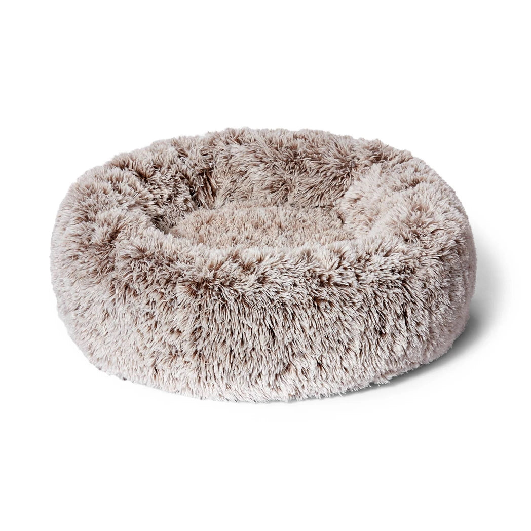 Round fluffy beige Snooza pet bed on a white background