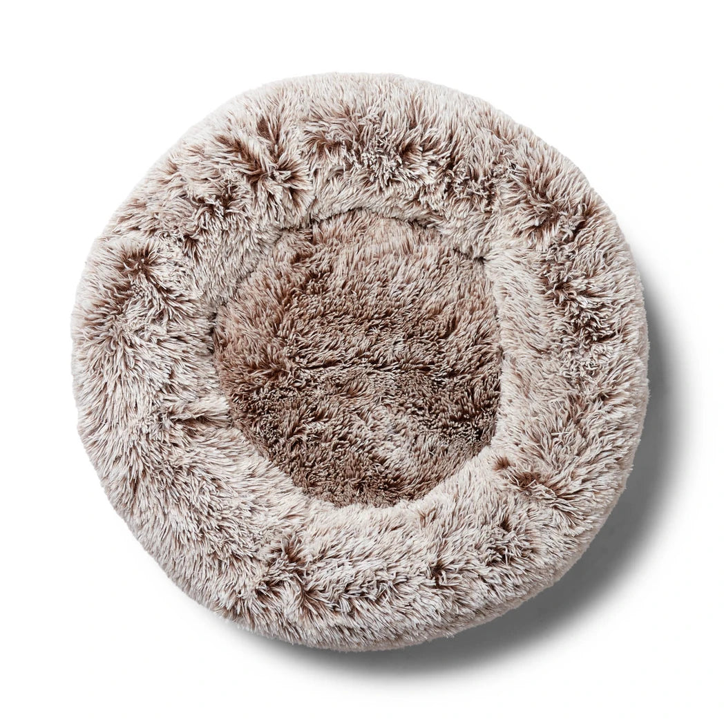Round fluffy beige Snooza pet bed on a white background